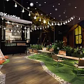 Cozy Outdoor Cafe Space With String Lights Teepee Grass And Wooden Seating 3d model