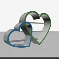 Heart Shaped Cookie Cutters With Blue And Green Edges On Light Background