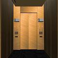 Modern Elevator Interior Featuring Sleek Wooden Panels And Warm Lighting Strip 3d model