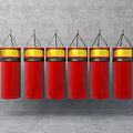 Six Red Cylindrical Pendants With Gold Top Rings Hanging By Chains On Gray Background