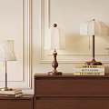 Different Style Table Lamps On Wooden Cabinets With Books And Green Plant