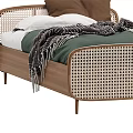 Modern Single Bed Featuring Wooden Frame Rattan Panels Green Sheets And Gray Blanket
