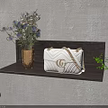 White Handbag With Gold G Logo And Chain Strap On Wooden Shelf With Green Plants