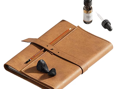 Brown Leather Notebook With Pencil Essential Oil Bottle Dropper And Black Aromatherapy Stones 3d model