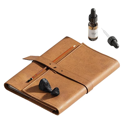 Brown Leather Notebook With Pencil Essential Oil Bottle Dropper And Black Aromatherapy Stones 3d model