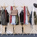 Stylish Clothes Hangers With Hanging Clothes Bags And Hats Against Geometric Patterned Wall