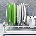 Kitchen Cabinets With Dish Rack Featuring Green White Plates And Wooden Spoons On Marble Countertop