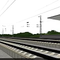 Railway Tracks And Concrete Platform Featuring Overhead Lines And Steel Poles