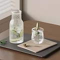 Refreshing Water With Lemon Slices In Glass Bottle And Cup On Black Tray Wooden Table