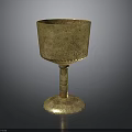 Golden Engraved Cup With Stemmed Base And Ornate Design For Household Use