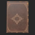 Vintage Book with Brown Leather Cover and Intricate Circular Decorative Pattern