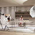 Public Office Space With Person At Desk Photography Equipment Shelves Bottles Lighting And Green Plants
