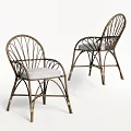 Rattan Leisure Chairs With Curved Frame And Light Gray Cushions For Outdoor Use