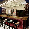 Stylish Bar Counter With Black High Stools Red Cushions White Wooden Decor And Wine Racks