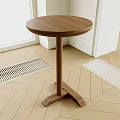 Round Wooden Side Table in Room with Geometric Floor White Door Frame and Metal Grille