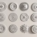 White Ceiling Medallions With Various Decorative Designs Displayed On Light Background