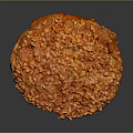 Golden Brown Round Pastry Topped with Crushed Nuts and Sweet Glaze