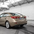 Golden Tan Sedan Car With Modern Sleek Exterior And Alloy Wheels In Indoor Showroom