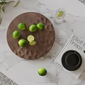 Fresh Limes On Wooden Tray Over Marble Surface With Greenery And Water Glass