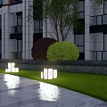 Square Outdoor Lights Illuminating Modern Building Lawn With Stone Pavement And Bushes