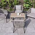 Outdoor Rattan Table And Chairs Set With Wooden Top Green Plants And Stone Tiles Floor