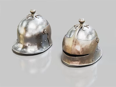 Two Antique Metal Helmets With Decorative Tops And Riveted Edges On Shiny Surface 3d model