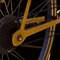 Modern Yellow Bicycle With Black Seat Handlebar And Orange Rimmed Wheels