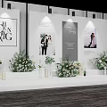 Elegant Wedding Stage Decor With Floral Arrangements And Photo Posters