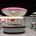 Modern Specialty Store Interior Featuring Central Display Counter Organized Shelves And Unique Lighting Design