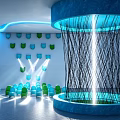Indoor Art Installation Featuring Blue Circular Structure Black Woven Lines Colorful Chairs And Wall Decorations
