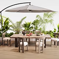 Outdoor Table With Curved Umbrella On Wooden Deck Surrounded By Plants And Chairs