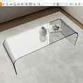 Sleek Glass Coffee Table With Curved Legs On Soft Carpet And Decorative Vase
