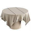 Elegant Round Dining Table with Beige Fabric Tablecloth and Soft Draped Edges