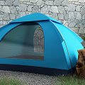 Blue Camping Tent With Mesh Window Near Stone Wall And Backpack On Grass