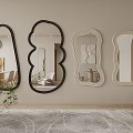 Various Shaped Mirrors Hanging On Wall In Interior With Carpet And Plant