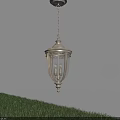 Classic Metal Outdoor Pendant Light With Glass Shade Illuminated Over Grass