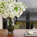 White Lilies and Roses in Clear Vase on Wooden Table with Blinds and Green View