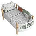 White And Wooden Kids Bed With Safety Railings Decorative Pillows And Patterned Sheets
