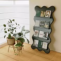 Black Wavy Bookcase With Books And Photos In Interior With Plants Window And Wooden Floor