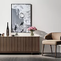 Console Cabinet With Abstract Painting Decorative Vase Pink Flowers And Beige Chair