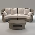 Curved Beige Wicker Sectional Sofa With Dark Brown Cushions And Matching Round Coffee Table