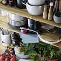 Organized Kitchen Utensils with Stacked Plates Pots and Glass Bottles on Wooden Shelves