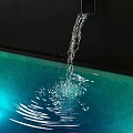 Garden Water Feature With Flowing Water Creating Ripples And Splashes Against Black Background