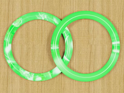 Decorative Ornament Set Two Green Circular Ring Shaped Decor Pieces on Wooden Surface 3d model