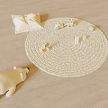 Woven Beige Round Rug with Pillow Stuffed Animal and Small Toys on Wooden Floor