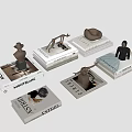 Elegant Stacked Art Magazines With Decorative Sculptures And Figurine Displays