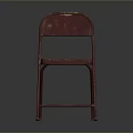 Vintage Red Folding Chair With Worn Metal Frame And Simple Background