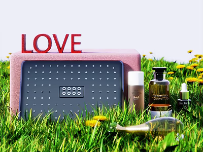 Perfume Cosmetics Placed on Green Grass with Yellow Flowers LOVE Sign and Pink Box 3d model