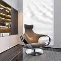 Modern Gray Accent Chair with Metal Frame Swivel Base and White Blinds Near Bookshelf
