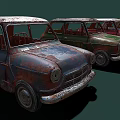 Vintage Rusty Cars in Various Colors Lined Up Against Dark Background